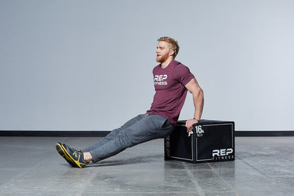 Individual performing dips on the Medium REP 3-in-1 Soft Plyo Box.