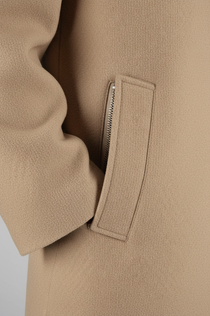Close-up of the pocket detail on a Coat windvanger camel, showcasing the modern fabric and design.