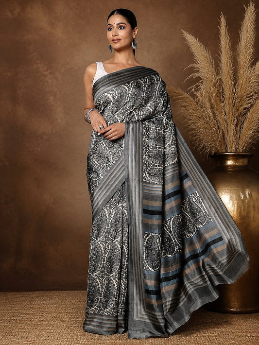 Grey, black and white large paisley printed saree with a grey-toned striped border and end-panel, styled with a reference blouse.