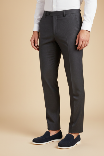 Model wearing dark gray tailored pants paired with navy loafers and a white shirt.