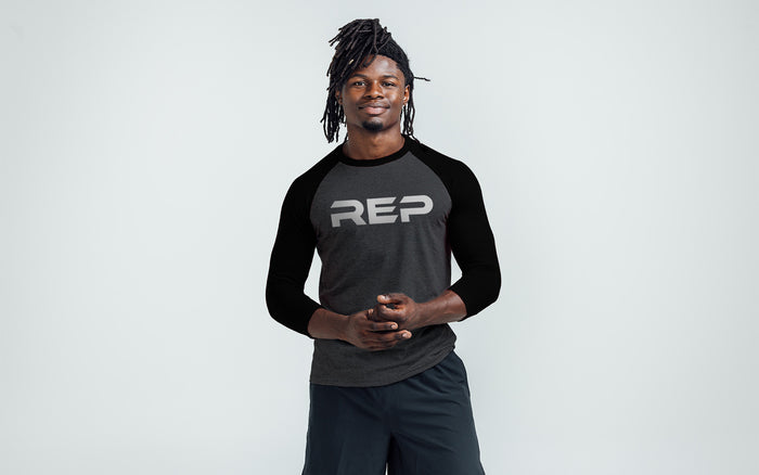 The REP Fitness Men's Daily Driver ¾ Sleeve Tri-Blend Crew T-Shirt in Heather Black/White on body