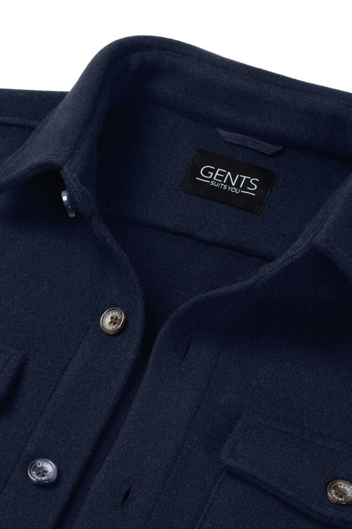 Overshirt navy detail showing GENTS label and buttons on a navy fabric with two chest pockets.