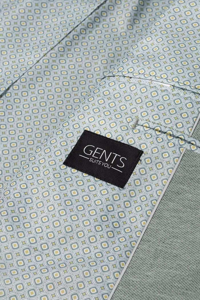 Detail van een Pak stretch groen met GENTS label, ideaal voor zakelijk en sociaal gebruik.