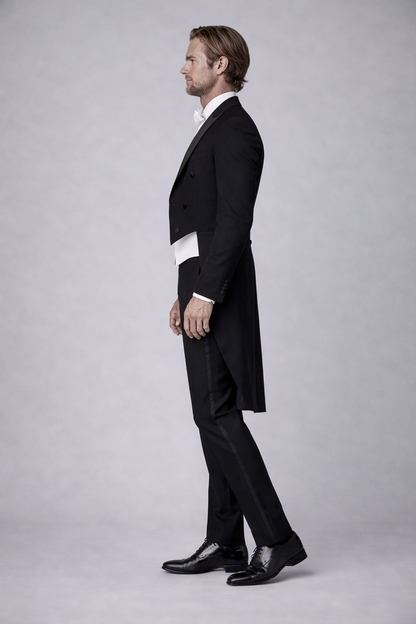 Elegantly dressed man in a formal Rokkostuum compleet, suitable for events with strict dress codes.