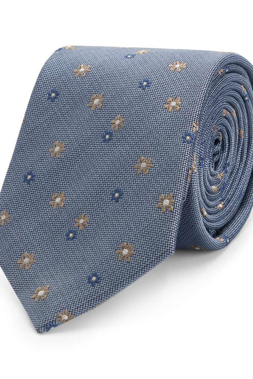 Stropdas zijde bloem blauw met glanzend bloemendessin op een lichtblauwe achtergrond.