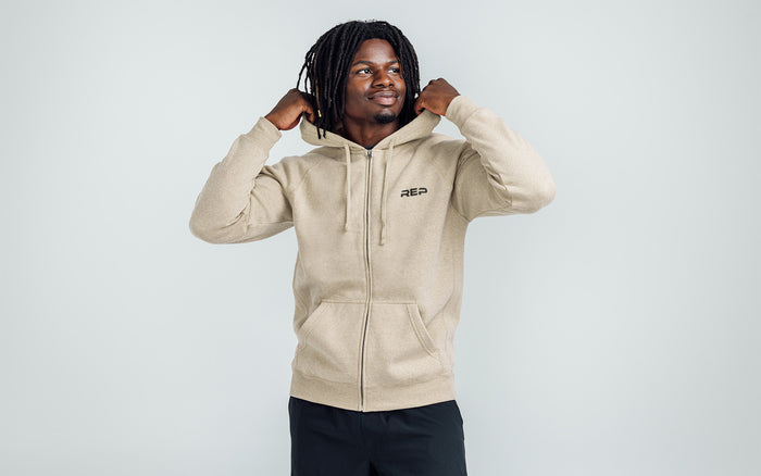 The REP Fitness Unisex Zip Hoodie in Heather Stone/Black on body