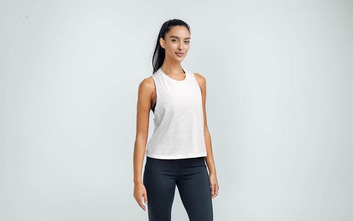 The REP Fitness Women's Peak Cropped Dual-Blend Tank in White/Aqua Gray on body