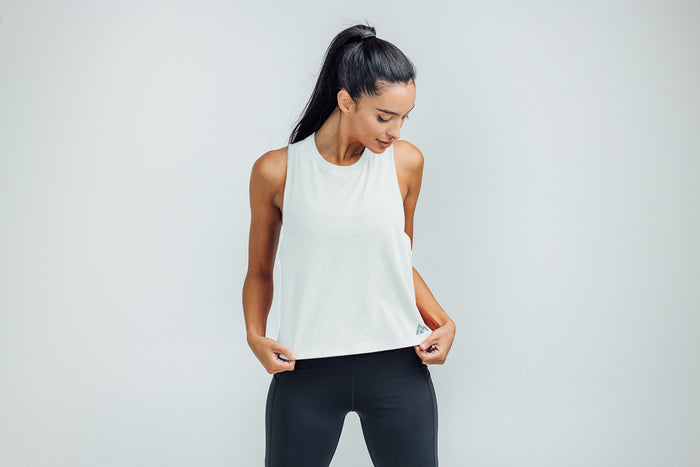 The REP Fitness Women's Peak Cropped Dual-Blend Tank in White/Aqua Gray on body